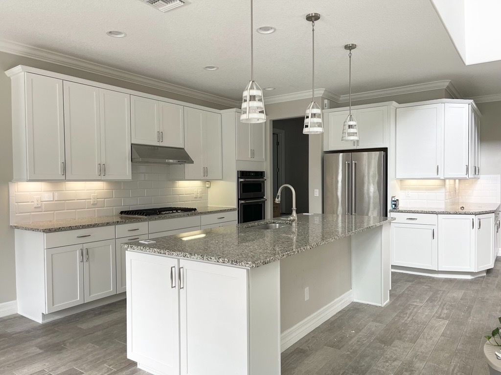 Kitchen cabinetry refinished in white