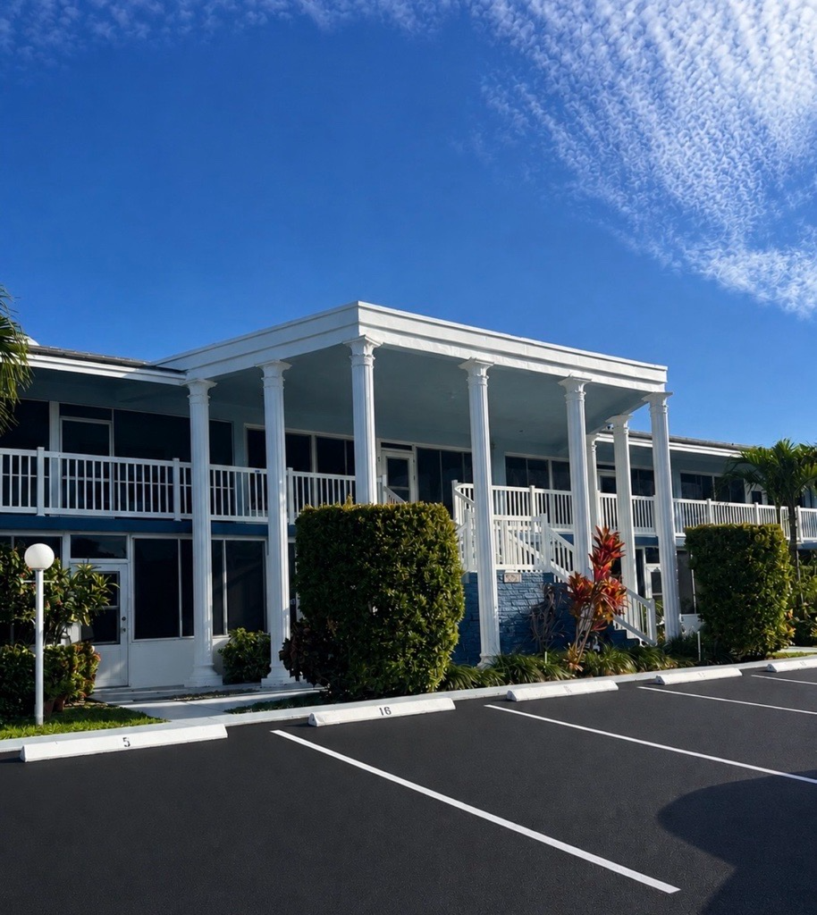 Condominium complex after a full exterior repaint — columns, railings and balconies