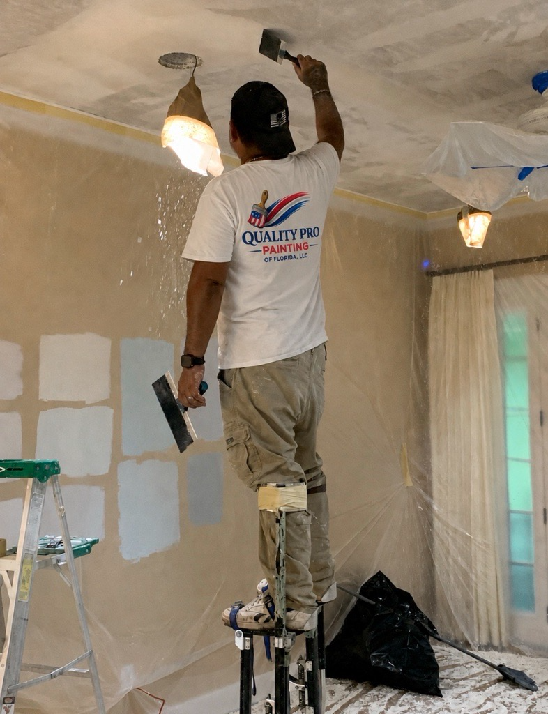 Quality Pro Painting crew member in branded uniform prepping a ceiling
