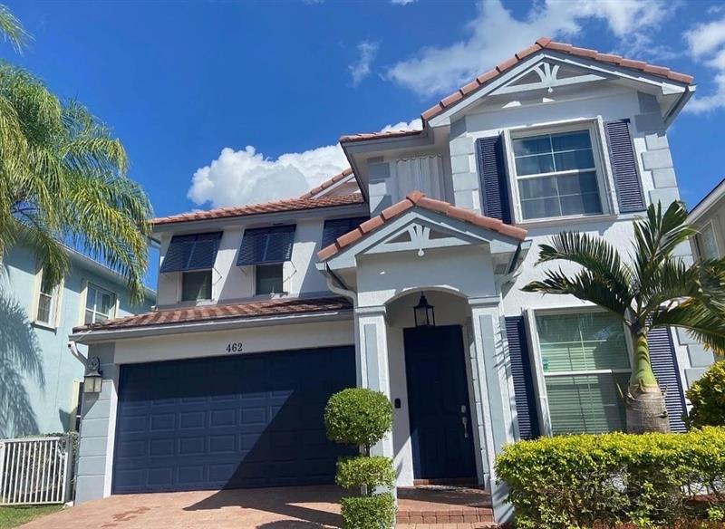 Coastal two-story in soft blue with navy trim