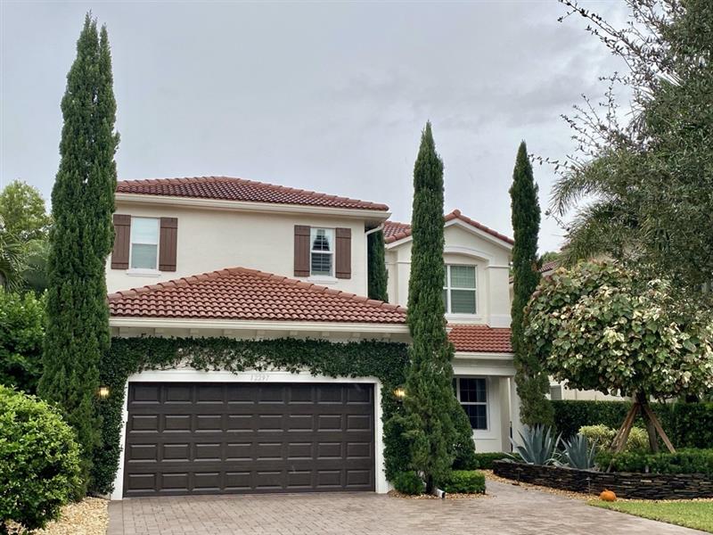 Two-story home with repainted stucco, shutters and doors