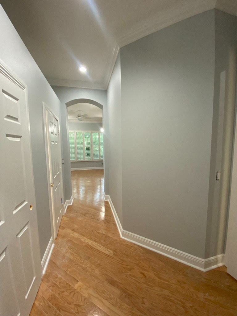 Interior corridor repainted in soft gray with white trim
